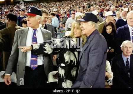 Atlanta Braves fan former President Jimmy Carter cheers during the seventh  inning stretch as a group sings God Bless America during Game 3 of the  National League Championship Series at Turner Field