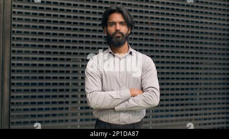 Bearded Indian businessman with arms crossed outdoors Stock Photo - Alamy
