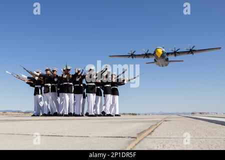 U.S. Marines of the Silent Drill Platoon, Marine Barracks Washington, execute their 'bursting bomb” sequence during the Blue Angels’ “Fat Albert” C-130J Super Hercules fly-over at Marine Corps Air Station (MCAS) Yuma, Arizona, Feb. 28, 2023. The Silent Drill Platoon and the Blue Angels flight crew held a photoshoot on the MCAS Yuma runway. (U.S. Marine Corps photo by Lance Cpl. Jade Venegas) Stock Photo