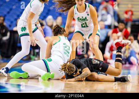 Greensboro, NC, USA. 3rd Mar, 2023. Notre Dame Fighting Irish forward Kylee Watson (22) knocks NC State Wolfpack guard Aziaha James (10) to the ground during the quarterfinals of the Women's ACC Tournament at Greensboro Coliseum in Greensboro, NC. (Scott Kinser/Cal Sport Media). Credit: csm/Alamy Live News Stock Photo