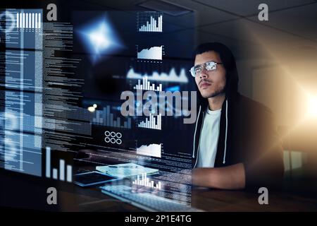 He can hack through any security measure. Shot of a young hacker cracking a computer code in the dark. Stock Photo