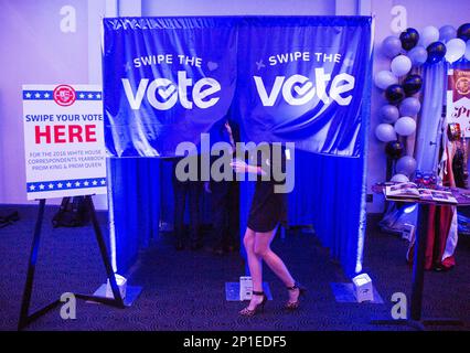 A woman walks between voting booths at the Landtn Thiel 470 VFW post as  citizens take to the polls to cast their votes for the Wisconsin's primary  Tuesday, Feb. 19, 2008, in