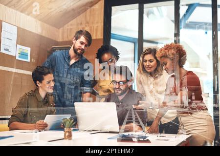 Combining their skills and efforts to drive success forward. Multiple exposure shot of businesspeople having a meeting superimposed over a cityscape. Stock Photo