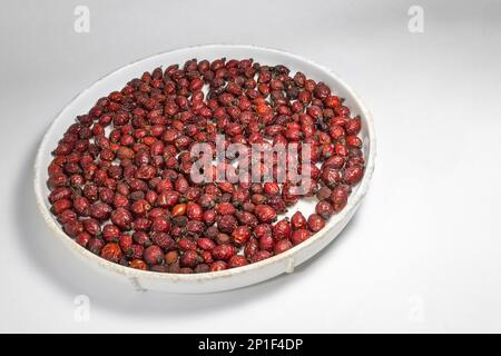 dried rose hips on a plate Stock Photo