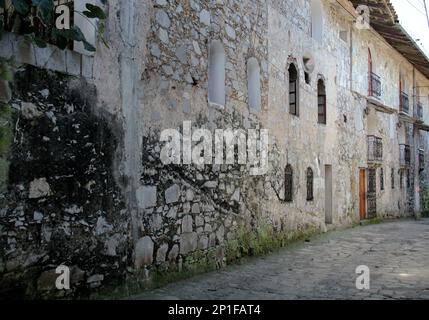 View of streets and traditional facades, houses with door, windows and tile roof in Cuetzalan Puebla Mexico Stock Photo