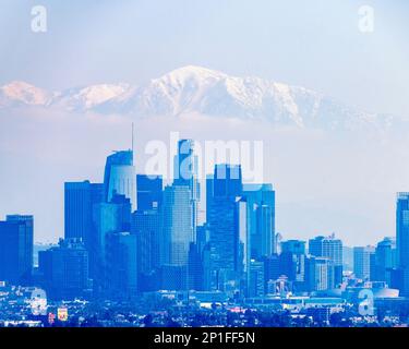 March 3, 2023, Los Angeles, CA, USA: A view of downtown LA with the snowy peak of Mount Baldy and the San Gabriel Mountains behind it, in Los Angeles, Stock Photo