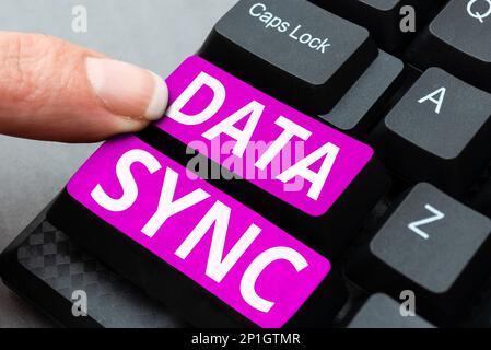 Hand writing sign Data Sync. Word for data that is continuously generated by different sources Stock Photo