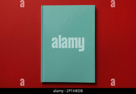 New stylish planner with hard cover on red background, top view Stock Photo