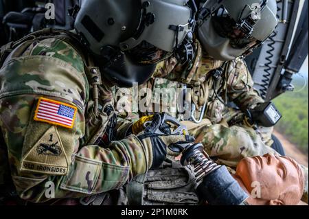 U.S. Army Staff Sgt. Anthony Marotta, left, and Sgt. Jeff Angle, UH-60L  Black Hawk helicopter crew chiefs with the New Jersey National Guard's  1-150th Assault Helicopter Battalion, conduct gear checks before hoist