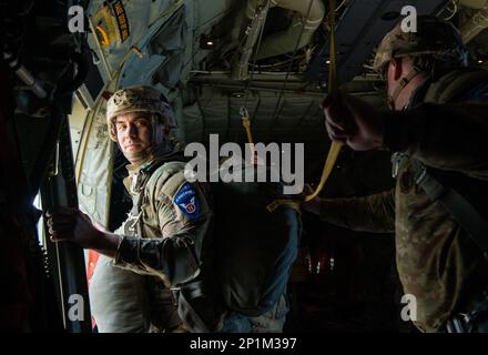 A Japan Ground Self Defense Force paratrooper prepares to hook his