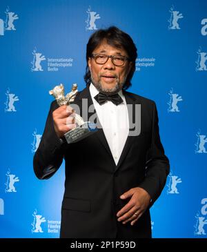 Mark Lee Ping-Bing, cameraman of 'Chang Jiang Tu' holds a Silver Bear for Outstanding Artistic Contribution during the award ceremony of the 2016 Berlin Film Festival Berlinale on Saturday, Feb. 20, 2016 in Berlin, (Bernd von Jutrczenka/pool photo via AP)