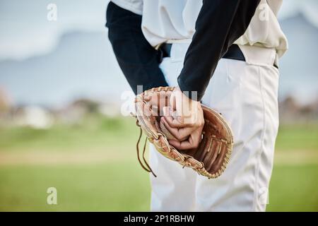 Hands, back view or baseball player training for a game or match on outdoor field or sports stadium. Fitness, softball or focused man pitching or Stock Photo
