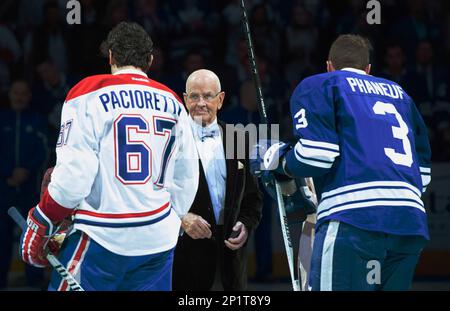 Nancy Bower, wife of the late NHL great Johnny Bower, watches a tribute to  her husband with former Toronto Maple Leafs players Frank Mahovlich, left,  and Dave Keon prior to NHL hockey