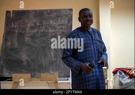 A Niger Armed Forces Affair Civil Militaire (FAN ACM) member explains his New Year’s Resolution during an English discussion class at the American Cultural Center, Agadez, Niger, Jan. 14, 2023. The FAN ACM attended the class after connecting with the center’s staff and donating books to the center’s library. The meeting was coordinated by the 443 Civil Affairs Battalion from AB 201. Stock Photo