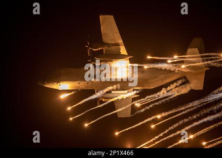 Royal Australian Air Force (RAAF) Lockheed Martin C-130J Super Hercules demonstrating a nighttime flare drop at the Avalon International Airshow 2023 Stock Photo