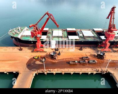 LIANYUNGANG, CHINA - MARCH 4, 2023 - Imported iron ore is unloaded and stacked at the port of Lianyungang, East China's Jiangsu province, March 4, 202 Stock Photo