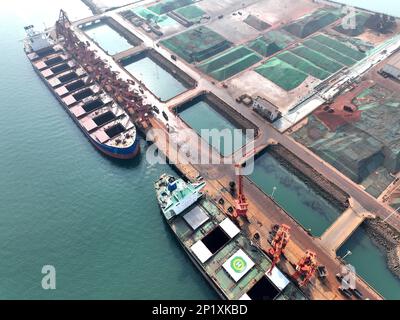 LIANYUNGANG, CHINA - MARCH 4, 2023 - Imported iron ore is unloaded and stacked at the port of Lianyungang, East China's Jiangsu province, March 4, 202 Stock Photo