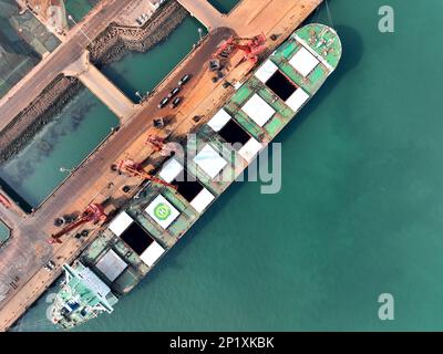 LIANYUNGANG, CHINA - MARCH 4, 2023 - Imported iron ore is unloaded and stacked at the port of Lianyungang, East China's Jiangsu province, March 4, 202 Stock Photo