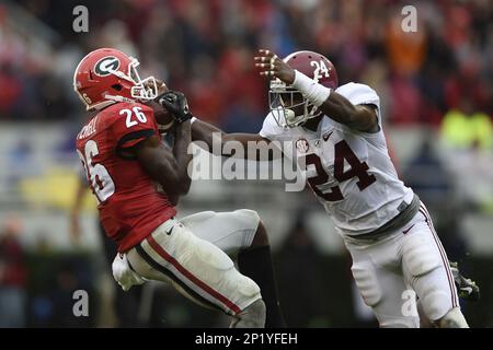 Receiver Malcolm Mitchell makes a catch for a first down and is tackled by  Geno Matias-Smith in the first quarter of the University of Georgia's game  against the University of Alabama, Saturday