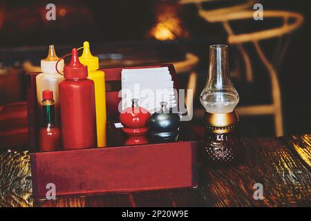 A set of sauces, spices, napkins for food on the table in pub, restaurant, cafe Stock Photo
