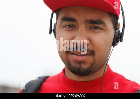Young black man listening to music in headphones. Portrait of handsome African male person looking in camera Stock Photo