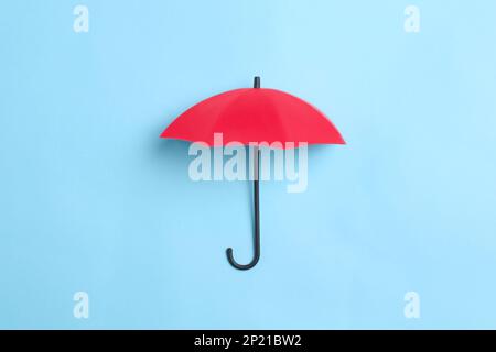 Bright toy umbrella on light blue background, top view Stock Photo