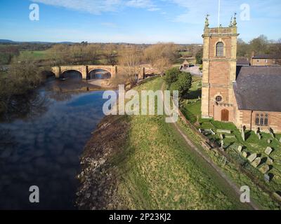 old bridge over the River Dee and church in Bangor-is-y-Coed in Wales Stock Photo