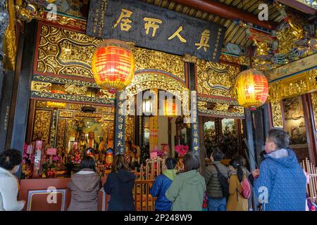 Taipei, Taiwan - January 25, 2023: People making offerings in the Baoan Temple in the Datong District, Taipei, Taiwan. Stock Photo
