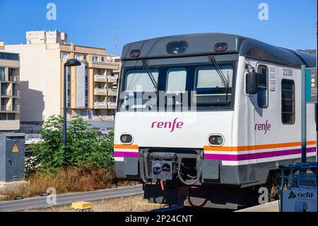 Alicante, Spain - July 14, 2022: A RENFE train stationary in the station's platform Stock Photo