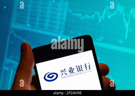 China. 19th Feb, 2023. In this photo illustration, the Chinese commercial bank Industrial Bank Co logo is seen displayed on a smartphone with an economic stock exchange index graph in the background. Credit: SOPA Images Limited/Alamy Live News Stock Photo