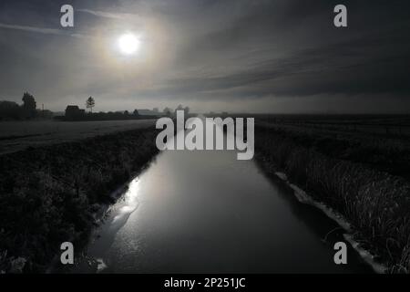 Winter frost over the North Level Main Drain, Gorefield village, Cambridgeshire, England, UK Stock Photo