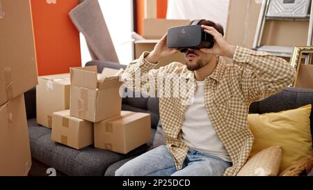 Young arab man using virtual reality glasses at new home Stock Photo
