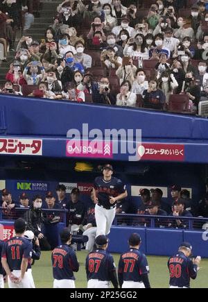 Shohei Ohtani of Japan's national baseball team smiles after hitting a  three-run home run in the third inning against the Hanshin Tigers in a  World Baseball Classic warm-up game on March 6