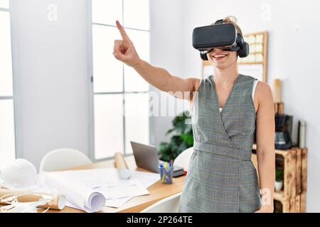 Young caucasian woman smiling confident using vr goggles working at architecture studio Stock Photo
