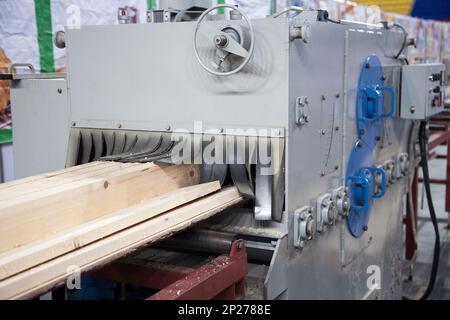 Big industrial sawmill cutting wood into boards. Woodworking facility producing lumber Stock Photo