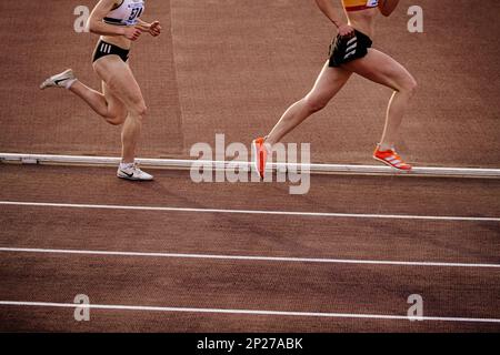 Chelyabinsk, Russia - June 4, 2022: female runners in spikes shoes Adidas and Nike running middle distance at stadium during UFD Athletics Championshi Stock Photo