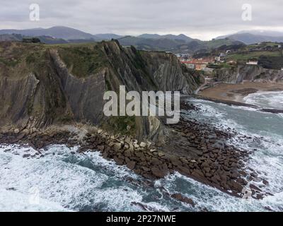 View on steeply-tilted layers of flysch geological formation on Atlantic coast at Zumaia at low tide, Basque Country, Spain Stock Photo