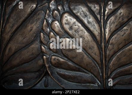 Big leaves close-up macro dark bronze metal relief background. Vintage water lily sculpture foliage art Stock Photo