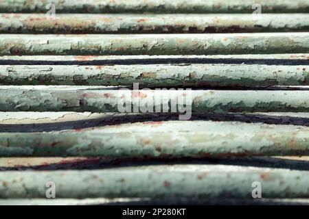Old green metal bars close-up background. Geometrical pattern on a shabby vintage messy backdrop Stock Photo