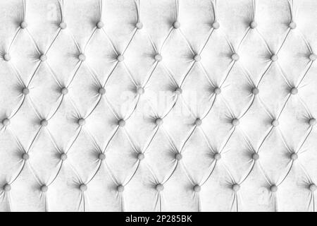 White capitone checkered soft fabric textile decorative background with buttons. Classic retro Chesterfield style, luxurious upholstery buttoned textu Stock Photo