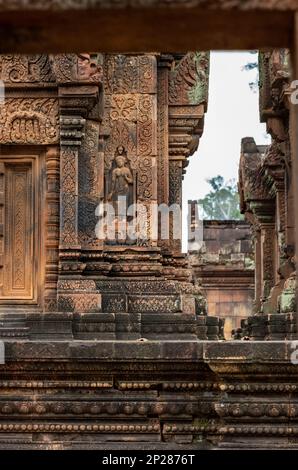 Elaborate carvings and bas reliefs in sandstone at the 10th century Bantaey Srey temple at Angkor near Siem Reap in Cambodia. Stock Photo