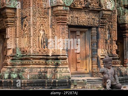 Elaborate carvings and bas reliefs in sandstone at the 10th century Bantaey Srey temple at Angkor near Siem Reap in Cambodia. Stock Photo