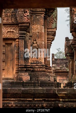 Elaborate carvings and bas reliefs in sandstone at the 10th century Bantaey Srey temple at Angkor near Siem Reap in Cambodia. Stock Photo