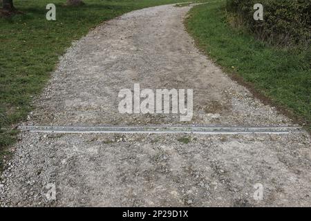 Gutter for drainage of a dirt road is clogged with gravel Stock Photo