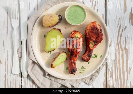 Top view of roasted chicken on rustic white table in summer Stock Photo