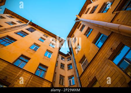 Traditional Court yard or well with bright yellow building in Saint-Petersburg, Russia Stock Photo