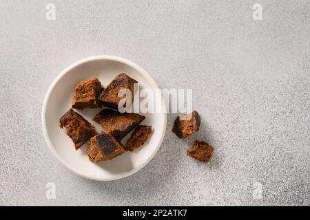 Kithul jaggery and treacle natural sweetener on gray background. View from above. Alternative sugar and superfood with low glycemic index. Palm-based Stock Photo