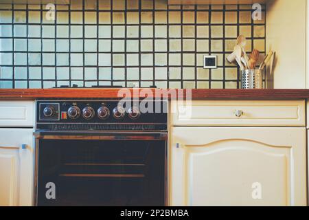 Vintage retro kitchen with green pattern tiles, american retro kitchen home interior design 70's 80's style close-up. retro Stock Photo