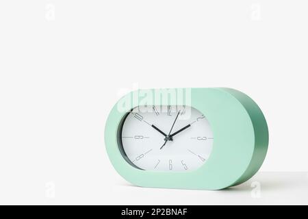 Contemporary clock modern alarm clock design white background studio new Stock Photo
