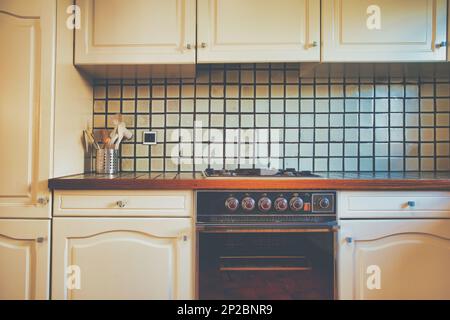 Vintage retro kitchen with green pattern tiles, american retro kitchen home interior design 70's 80's style close-up. retro Stock Photo